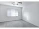 Bright, spacious bedroom with ceiling fan and a window for natural light at 3640 E Torrey Pines Ln, Chandler, AZ 85249