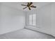 Well-lit, spacious bedroom with neutral carpet, ceiling fan, and window shutters at 3640 E Torrey Pines Ln, Chandler, AZ 85249