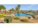 Large community pool with accessible chair lift and ample seating, surrounded by lush landscaping and inviting atmosphere at 3640 E Torrey Pines Ln, Chandler, AZ 85249