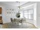 Airy dining area featuring a modern round table set, stylish decor, and abundant natural light from the window at 3640 E Torrey Pines Ln, Chandler, AZ 85249