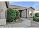 Home exterior featuring desert landscaping with decorative rock and mature green shrubs at 3640 E Torrey Pines Ln, Chandler, AZ 85249
