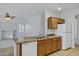 Kitchen with wood cabinets, stainless steel sink, tile floors, and view into adjacent living room at 3640 E Torrey Pines Ln, Chandler, AZ 85249