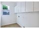 Laundry room featuring upper cabinets and a window letting in natural light at 3640 E Torrey Pines Ln, Chandler, AZ 85249