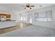 Open living room with carpet and tile flooring, kitchen, and access to the backyard at 3640 E Torrey Pines Ln, Chandler, AZ 85249
