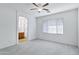 Large main bedroom with new carpet, ceiling fan, and an archway to bathroom at 3640 E Torrey Pines Ln, Chandler, AZ 85249