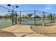 Community pickleball courts with fencing, lighting, and an adjacent sidewalk and bench at 3640 E Torrey Pines Ln, Chandler, AZ 85249