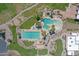 Aerial view of a resort-style community pool, complete with palm trees and lounge chairs at 3640 E Torrey Pines Ln, Chandler, AZ 85249