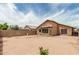 View of the backyard with block wall, small string lights, and desert landscaping at 3703 S 73Rd Dr, Phoenix, AZ 85043