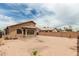 View of the backyard with block wall, small string lights, and desert landscaping at 3703 S 73Rd Dr, Phoenix, AZ 85043