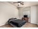 This bedroom includes a ceiling fan, neutral walls, and a classic wooden desk at 3703 S 73Rd Dr, Phoenix, AZ 85043