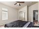 A spacious bedroom with a ceiling fan, closet, and window to allow ample sunlight at 3703 S 73Rd Dr, Phoenix, AZ 85043