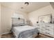 Comfortable bedroom showcasing tile floors, a large window, and lightly stained wooden furniture set at 3703 S 73Rd Dr, Phoenix, AZ 85043