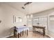 Dining room features hanging lights, table, mirror and large window providing abundant natural light at 3703 S 73Rd Dr, Phoenix, AZ 85043