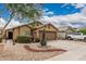 Desert landscape and gravel surround this single-story home with a two-car garage at 3703 S 73Rd Dr, Phoenix, AZ 85043