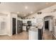 Bright kitchen featuring white cabinetry, granite countertops, stainless steel appliances, and tile flooring at 3703 S 73Rd Dr, Phoenix, AZ 85043