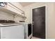 This laundry room includes modern Samsung washer and dryer machines and storage shelving at 3703 S 73Rd Dr, Phoenix, AZ 85043