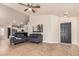 Living room featuring a tile floor, gray couches, white walls, and an entranceway at 3703 S 73Rd Dr, Phoenix, AZ 85043