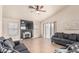 Cozy living room features a ceiling fan, tiled floors, fireplace, and neutral color palette at 3703 S 73Rd Dr, Phoenix, AZ 85043