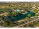 This aerial view features a community lake, swimming pool, basketball court, and picnic areas with trees at 3773 E Stampede Dr, Gilbert, AZ 85297