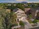 Expansive aerial view of a beautiful home surrounded by lush greenery and mountain views, showcasing its prime location at 3773 E Stampede Dr, Gilbert, AZ 85297