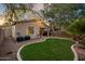 A well-maintained backyard with lush grass, a covered patio, and a manicured landscape, offering a serene retreat at 3773 E Stampede Dr, Gilbert, AZ 85297