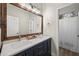Stylish bathroom featuring a double vanity with modern fixtures, framed mirror, and walk-in shower at 3773 E Stampede Dr, Gilbert, AZ 85297