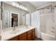 Bathroom with a double vanity, a shower-tub combo, and neutral finishes at 3773 E Stampede Dr, Gilbert, AZ 85297