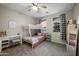 Charming bedroom with a stylish bunk bed, a cozy desk, chevron blinds, and a full-length mirror at 3773 E Stampede Dr, Gilbert, AZ 85297