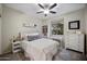 Serene bedroom with a comfortable bed, bookshelf, work desk, and plenty of natural light from the window at 3773 E Stampede Dr, Gilbert, AZ 85297