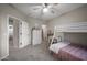Bedroom featuring bunk beds, work desk, dresser, ceiling fan, and neutral decor at 3773 E Stampede Dr, Gilbert, AZ 85297