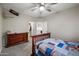 Neutral bedroom with wood bedframe, airplane decor, dresser, ceiling fan, and light grey carpeting at 3773 E Stampede Dr, Gilbert, AZ 85297