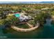 Picturesque aerial view of a community pool and recreation center nestled by a serene lake, perfect for leisure activities at 3773 E Stampede Dr, Gilbert, AZ 85297