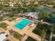 Aerial view of a vibrant community pool area, complete with lounge chairs and umbrellas, offering a refreshing oasis at 3773 E Stampede Dr, Gilbert, AZ 85297