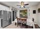 Eat-in kitchen with stainless steel fridge, sliding barn door, and a backyard view at 3773 E Stampede Dr, Gilbert, AZ 85297