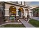 Charming front porch with stone columns and covered entryway, creating a welcoming facade at 3773 E Stampede Dr, Gilbert, AZ 85297