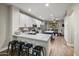 Bright kitchen with white cabinets, stainless steel appliances, quartz countertops and seating at 3773 E Stampede Dr, Gilbert, AZ 85297