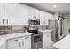 Well-equipped kitchen featuring white cabinets, stainless steel appliances, and modern finishes at 3773 E Stampede Dr, Gilbert, AZ 85297