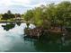Scenic aerial view of a tranquil lake featuring a charming wooden dock, ideal for peaceful relaxation and reflection at 3773 E Stampede Dr, Gilbert, AZ 85297