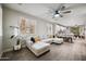 Open-concept living room with large sectional couch, wood-look floors, and bright natural light at 3773 E Stampede Dr, Gilbert, AZ 85297