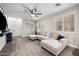 Spacious living room with wood-look floors, neutral walls, and plantation shutters, ample seating at 3773 E Stampede Dr, Gilbert, AZ 85297