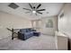 Bright loft area features plush carpeting, updated ceiling fan, and a comfortable blue sectional sofa at 3773 E Stampede Dr, Gilbert, AZ 85297