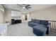 Loft space with a cozy sectional, custom storage, and a dedicated office area featuring built-in cabinets at 3773 E Stampede Dr, Gilbert, AZ 85297