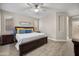 Bedroom with wood-look flooring, a ceiling fan, and a king-sized bed at 3773 E Stampede Dr, Gilbert, AZ 85297