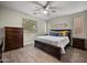 Bedroom with wood-look flooring, a ceiling fan, and a cozy feel at 3773 E Stampede Dr, Gilbert, AZ 85297