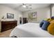 Bedroom with wood-look flooring, an ensuite bathroom, and natural lighting at 3773 E Stampede Dr, Gilbert, AZ 85297