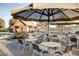 Enjoy dining al fresco at the pool with tables and chairs under a shade structure at 3773 E Stampede Dr, Gilbert, AZ 85297