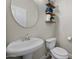 Powder room featuring a pedestal sink and decorative floating shelves at 3773 E Stampede Dr, Gilbert, AZ 85297