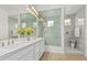 Bright bathroom with double vanity, a glass enclosed shower, and white cabinets at 3856 E Shannon St, Gilbert, AZ 85295