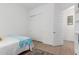 Bright bedroom featuring closet and entry door, with neutral paint, light flooring and a cozy bed at 3856 E Shannon St, Gilbert, AZ 85295