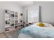 Bright bedroom featuring built-in bookshelves, a sunny window, and a cozy bed with a playful pillow at 3856 E Shannon St, Gilbert, AZ 85295